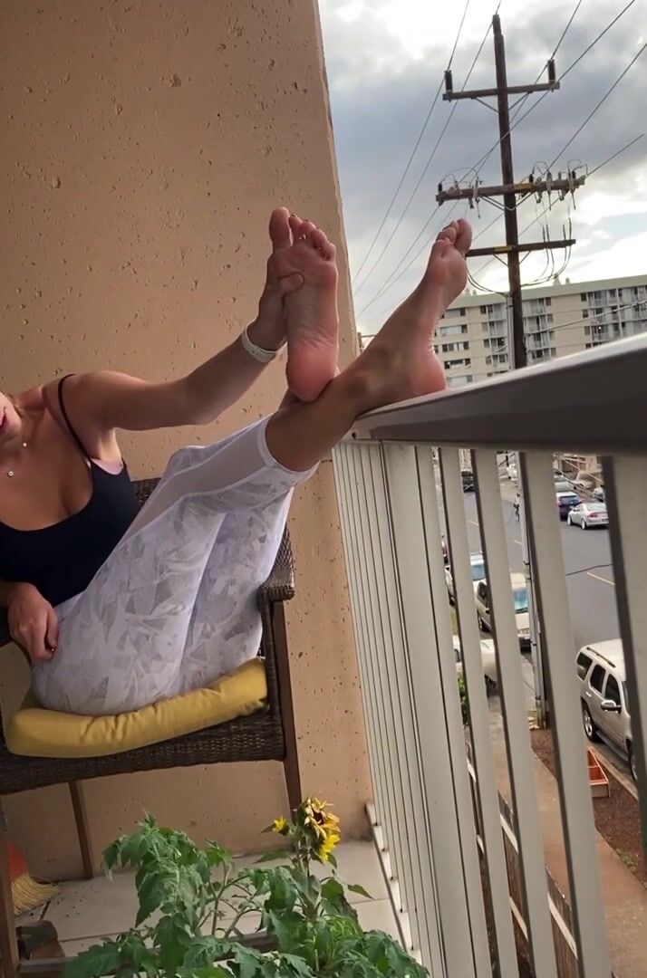 Natasha Burnz feet on the balcony