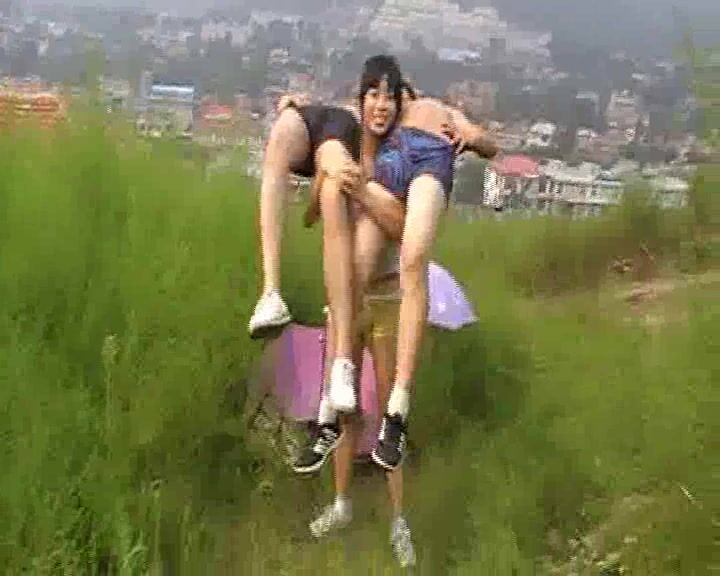 Strong Chinese woman carrying two men at the same time